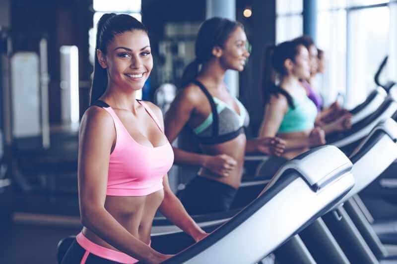 smiling woman using the treadmill