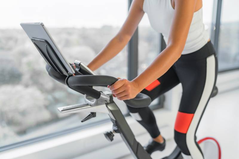 woman using exercise bike