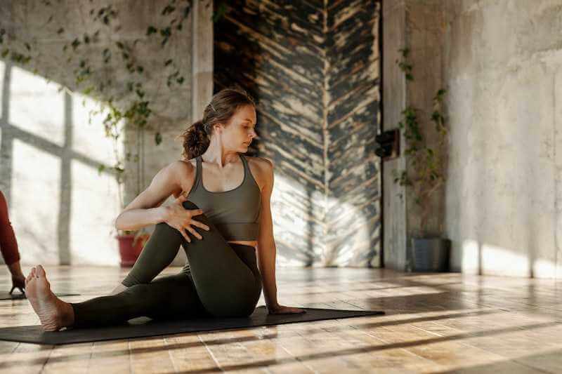 beautiful woman stretching on the yoga mat