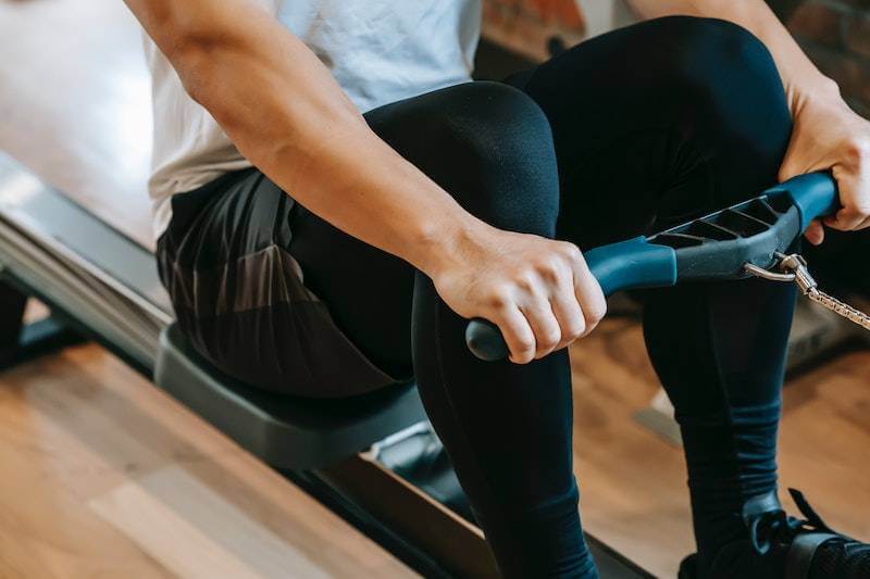 man using a rowing machine