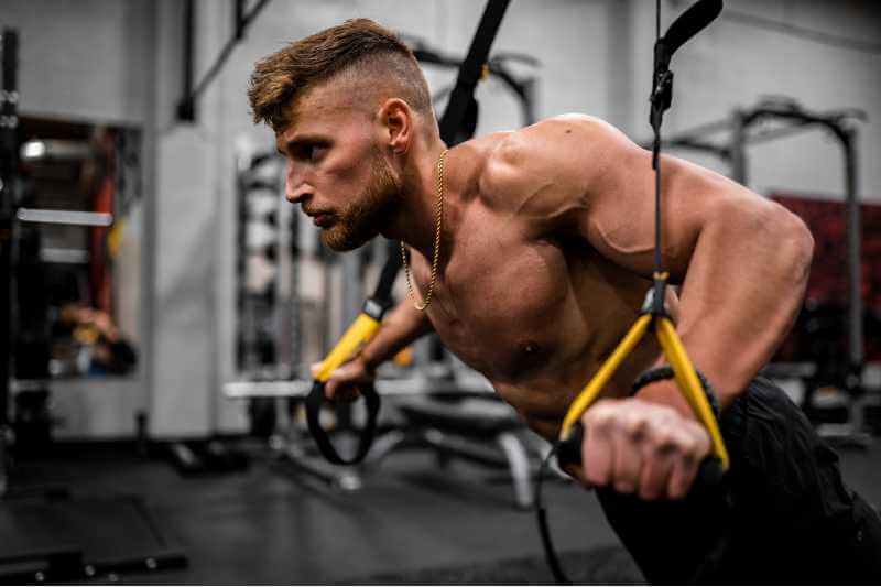 man doing arm exercises with gym machine