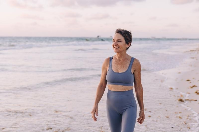 aged woman walking on the beach