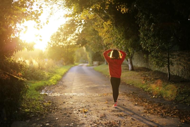 woman with red jacket walking alone