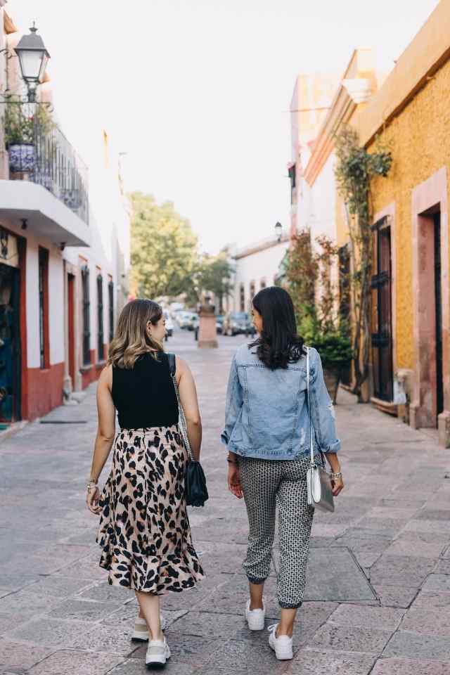 women chatting while walking