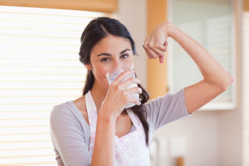 woman drinking a glass of milk